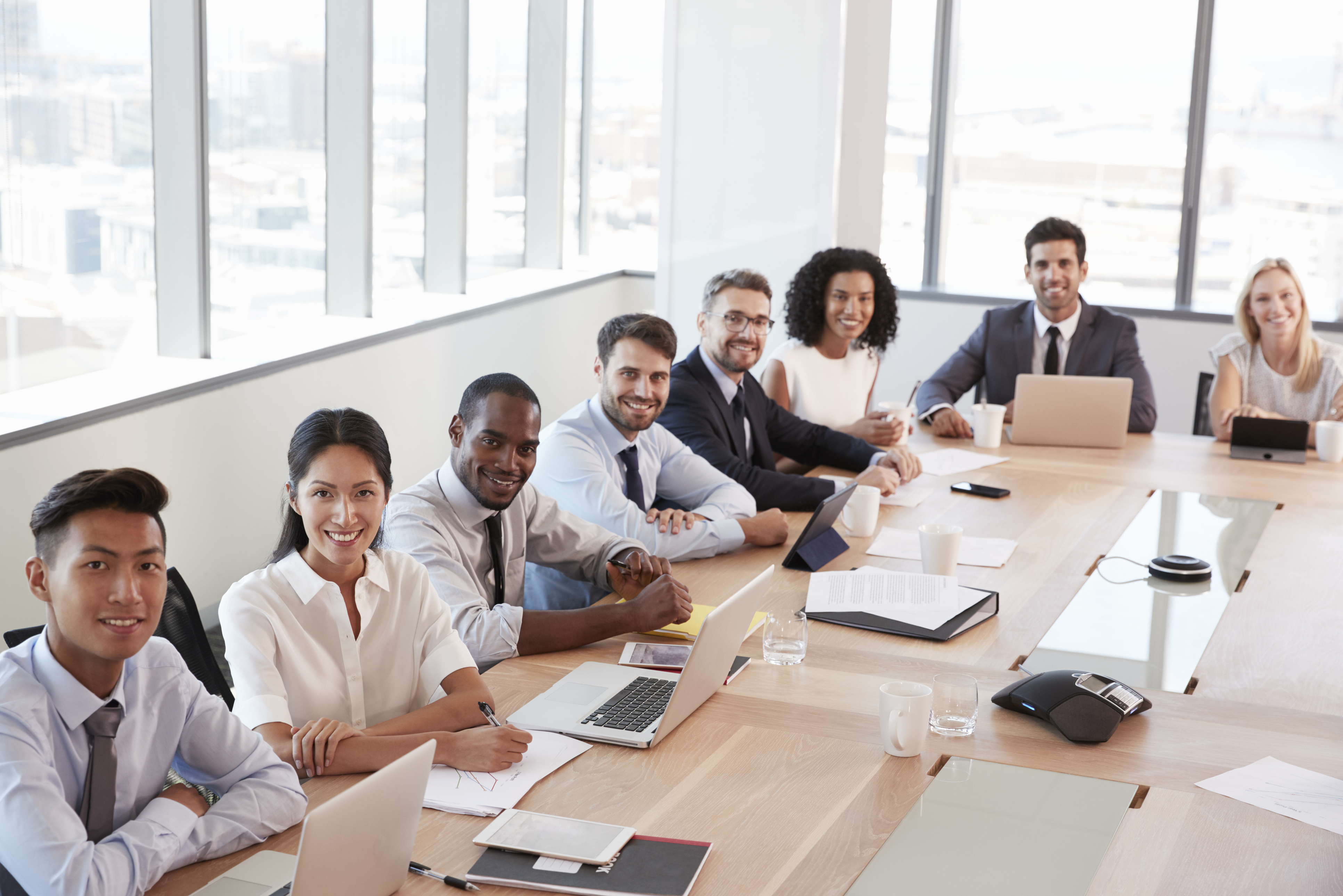 Portrait Of Businesspeople Around Boardroom Table - C6 Financial